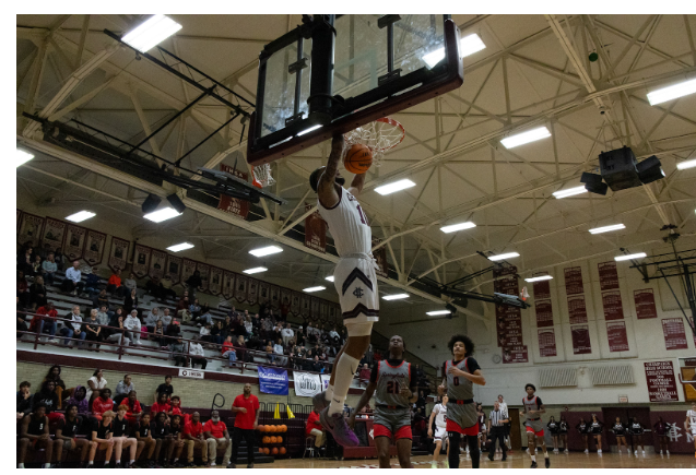 Champaign High School senior Chris Bush (#10) dunks the ball as Springfield players look on in Champaign’s Combes gym on December 4th, 2024.