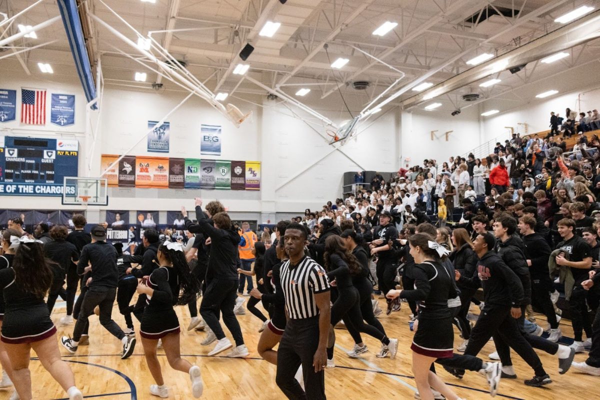 Champaign Central students rush the court at Coleman Carrodine Gymnasium at Centennial after Champaign’s boys' basketball team beat Centennial 75-62 on Friday, January 17th.