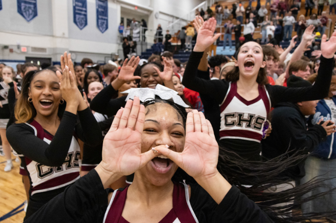 Champaign Central’s cheerleaders celebrate on the court after Central defeated crosstown rival Centennial 64-53 in the IHSA 3A Boys Basketball Regional Semifinals.